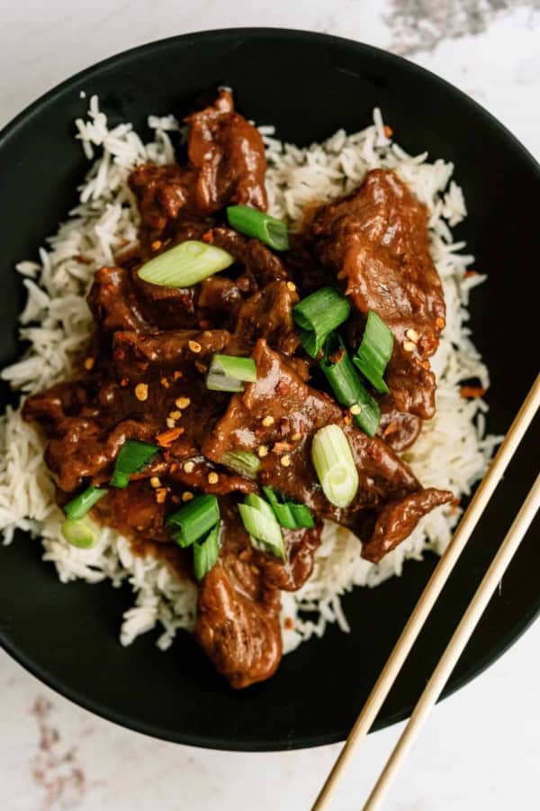 Delicious Mongolian beef served over white rice with green onions.