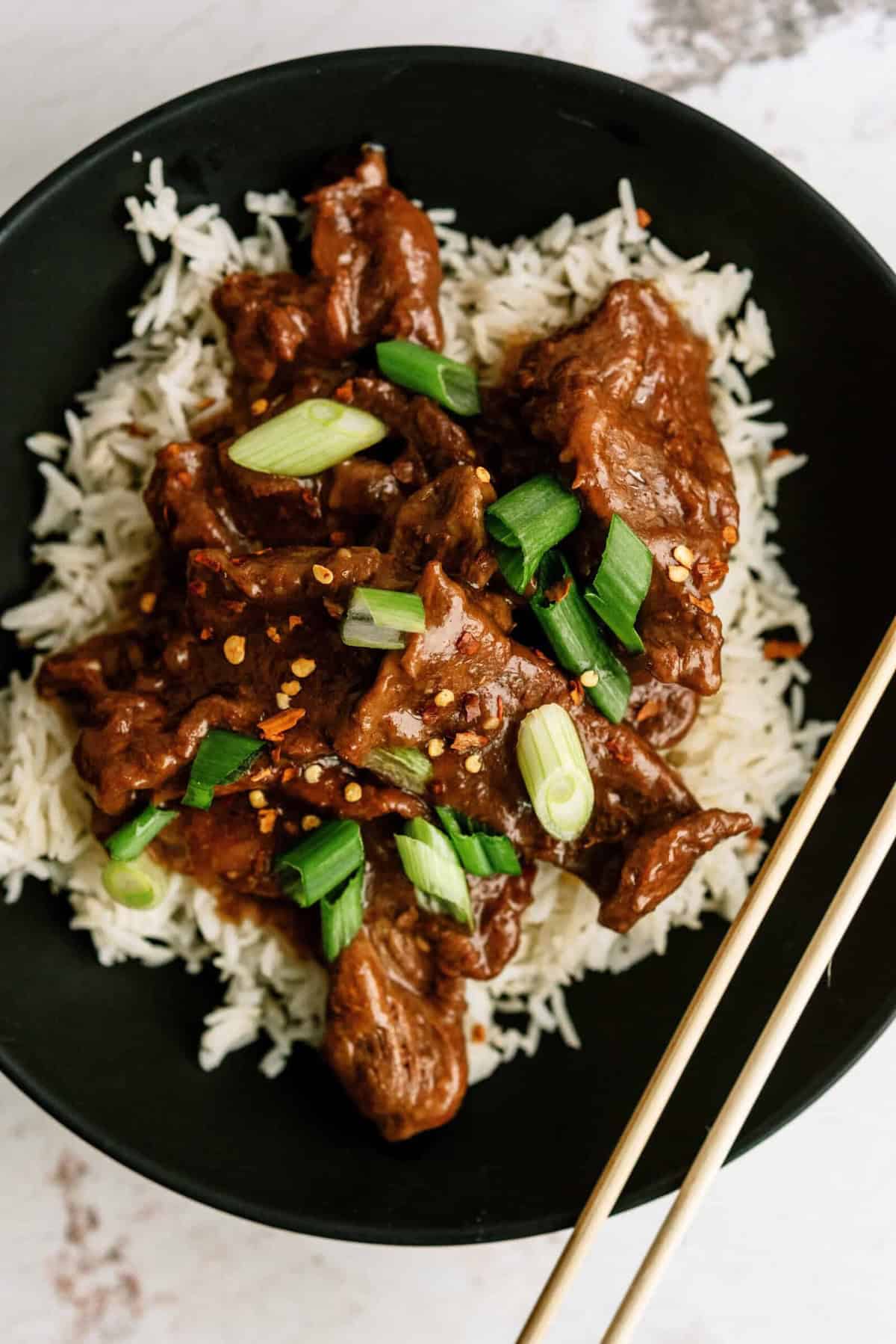Delicious Mongolian beef served over white rice with green onions.