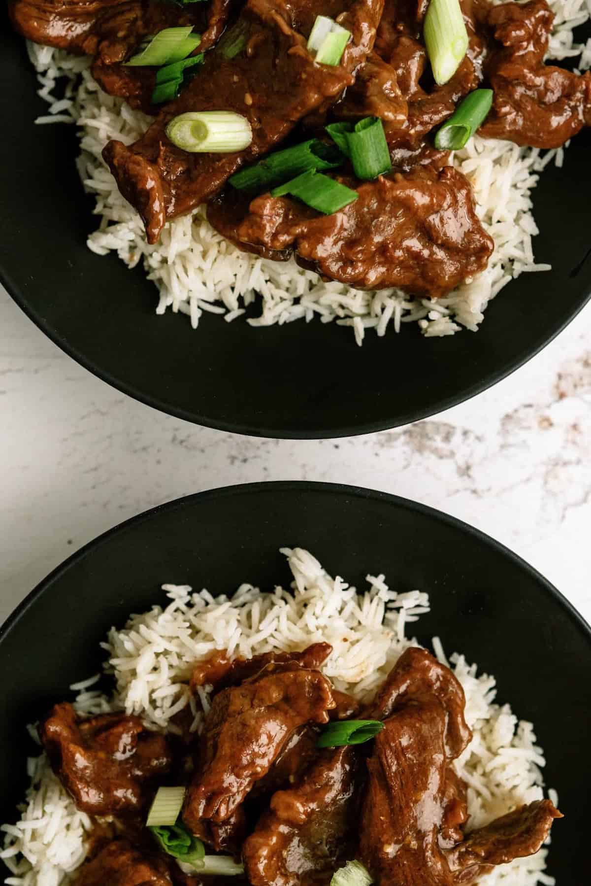 Delicious Mongolian beef served over white rice with green onions.