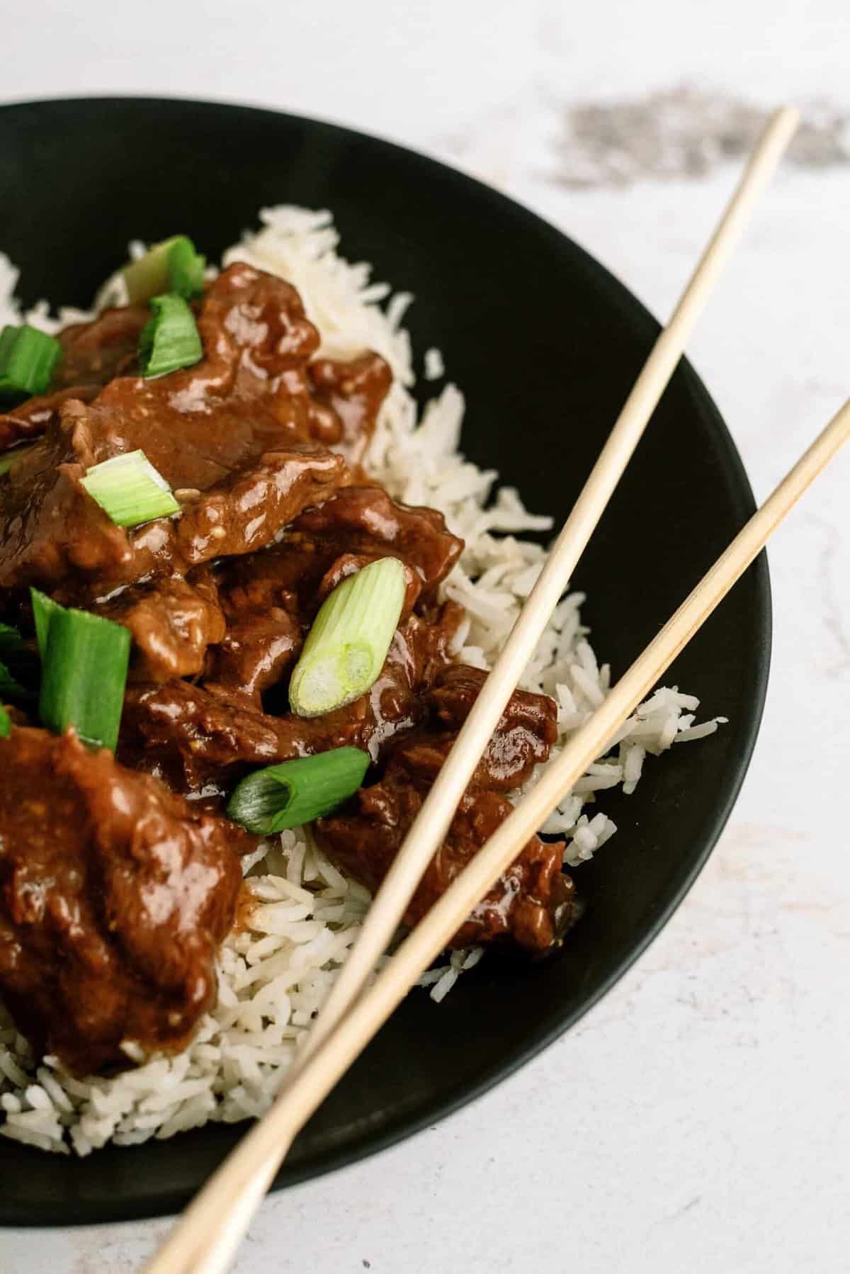 Delicious Mongolian beef served over white rice with green onions.