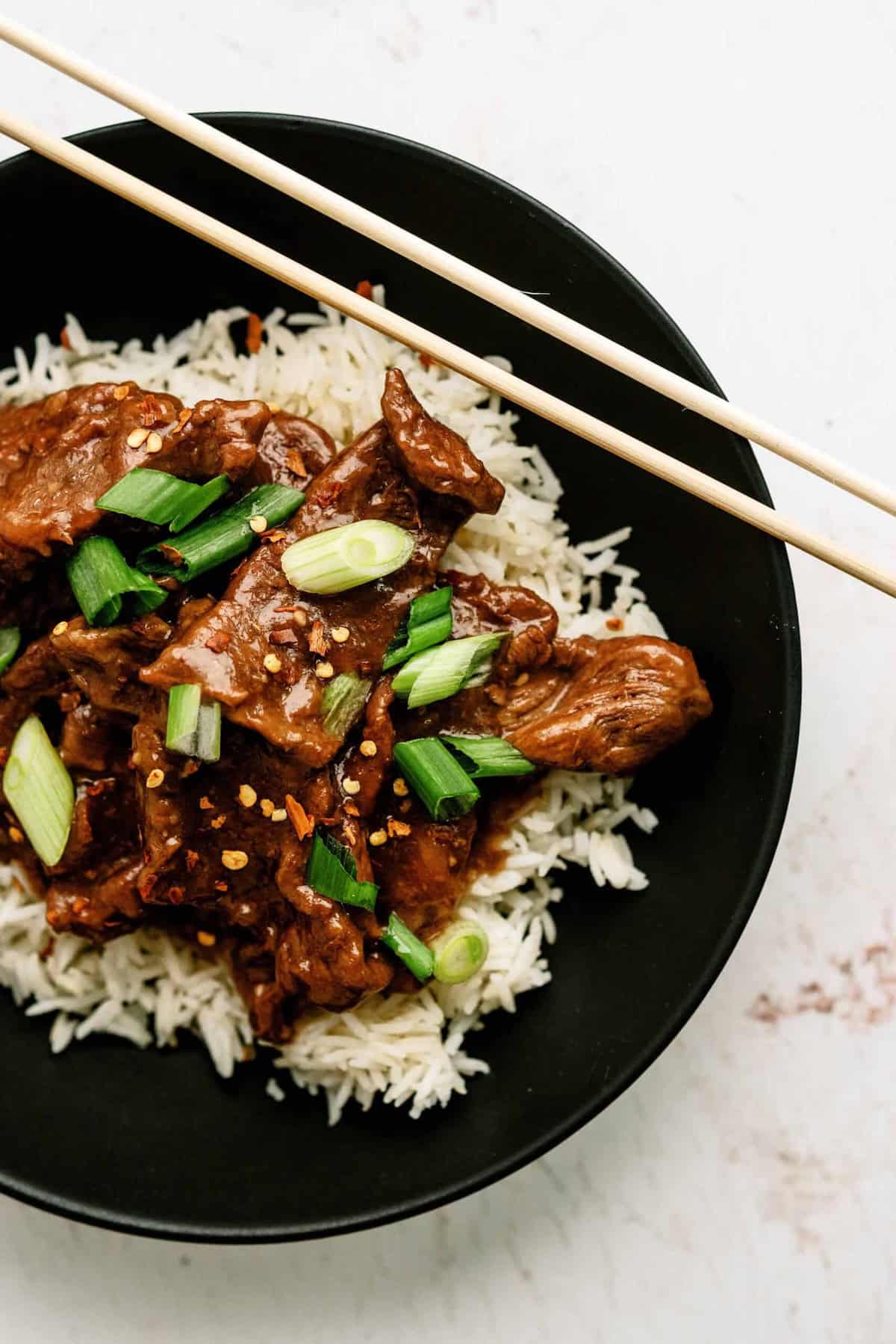 Delicious Mongolian beef served over white rice with green onions.