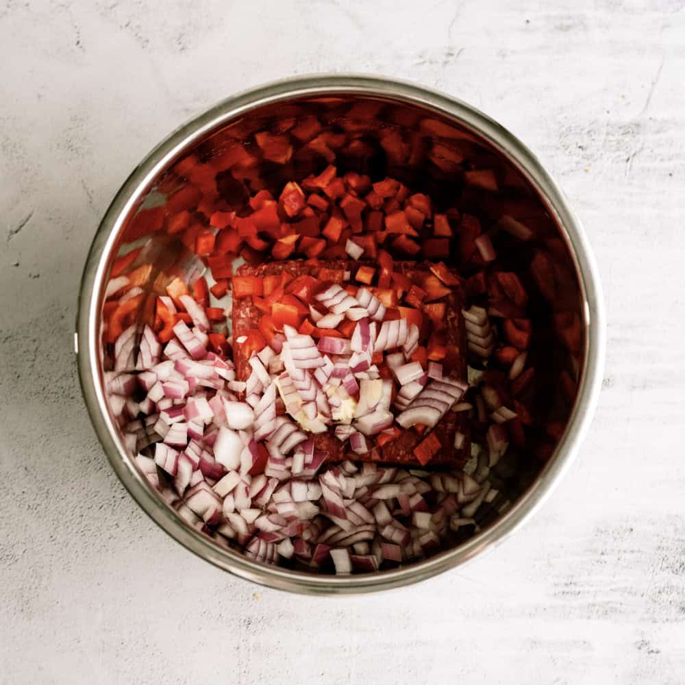 ground beef, peppers, and onion in bottom of instant pot