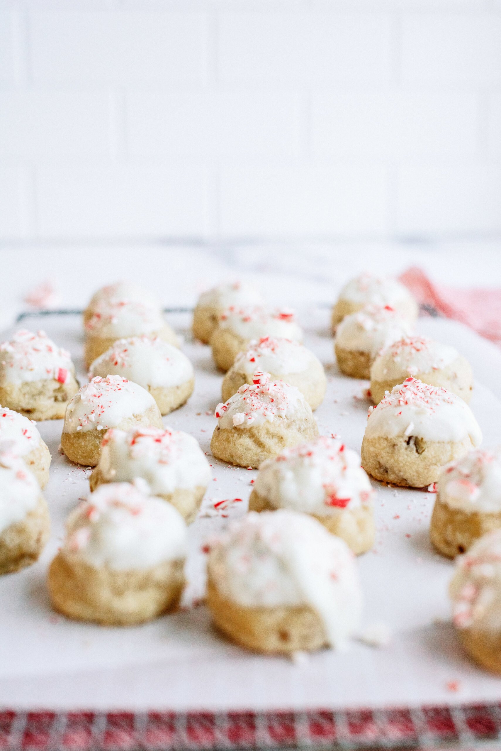 peppermint snowball cookies topped with candy canes