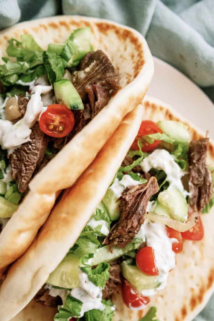 Close up of two Instant Pot Beef Gyros on a plate.