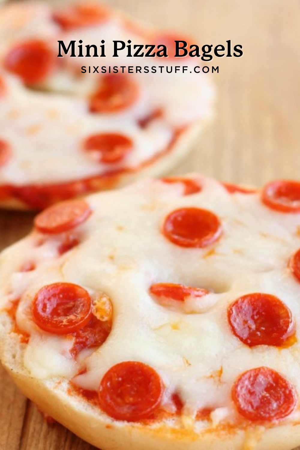 mini pizza bagels with pepperoni's on top on a wooden cutting board