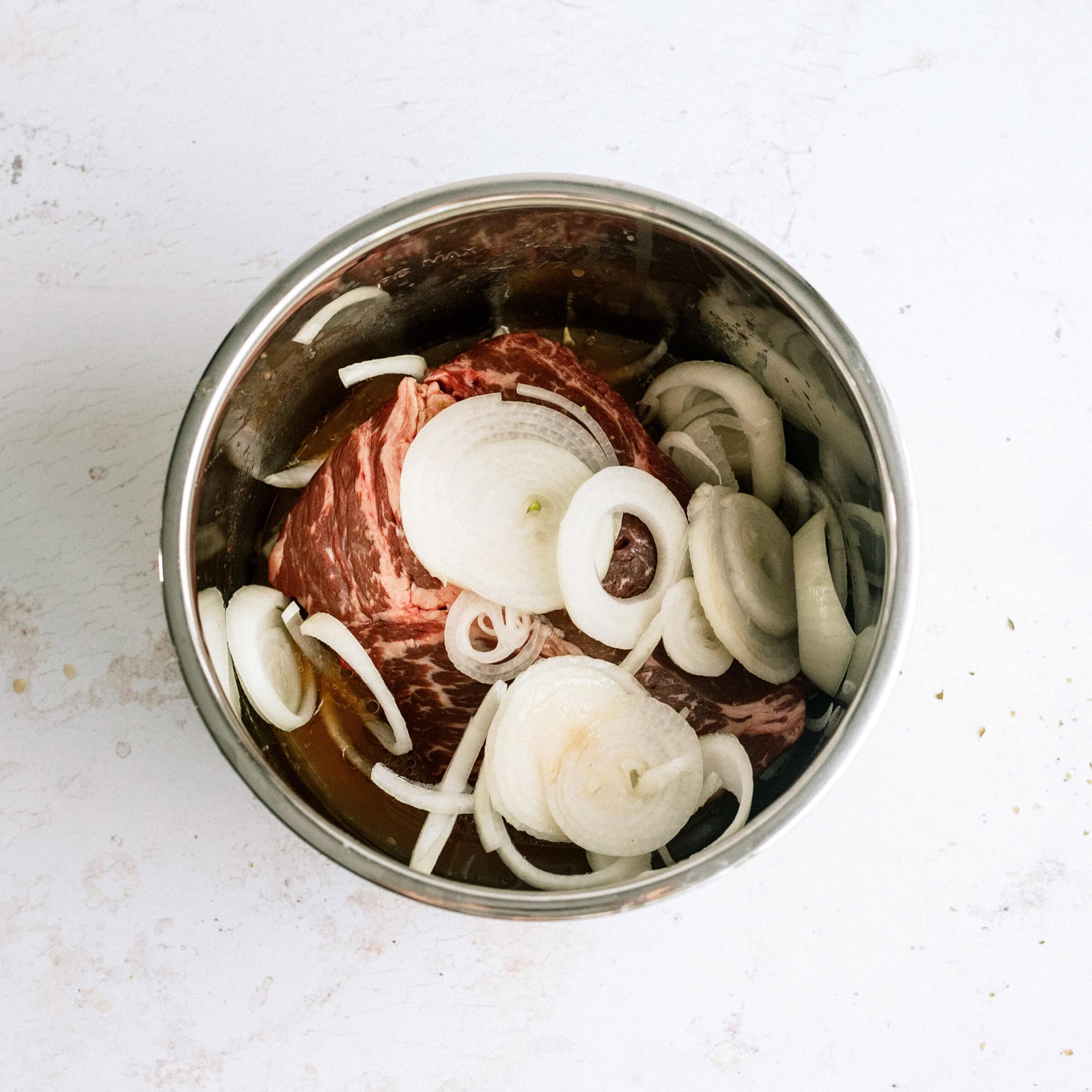 beef and onions in bottom of Instant Pot