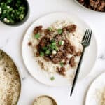 Korean beef served over rice with green onions and sesame seeds.