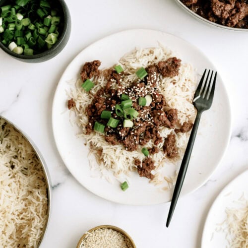 Korean beef served over rice with green onions and sesame seeds.
