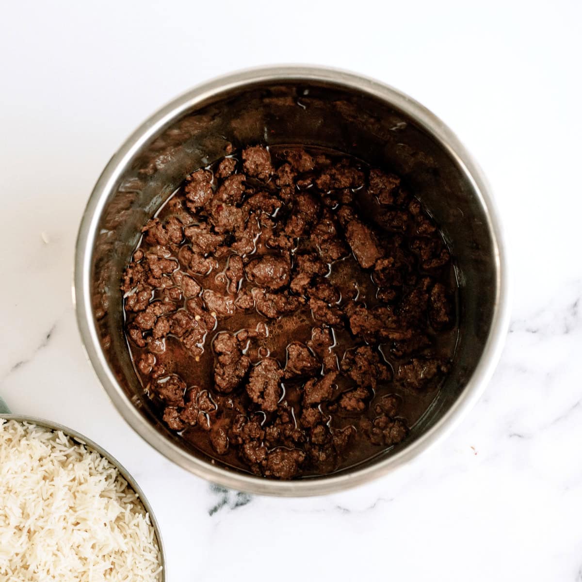 ground beef cooked in beef broth with rice on the side
