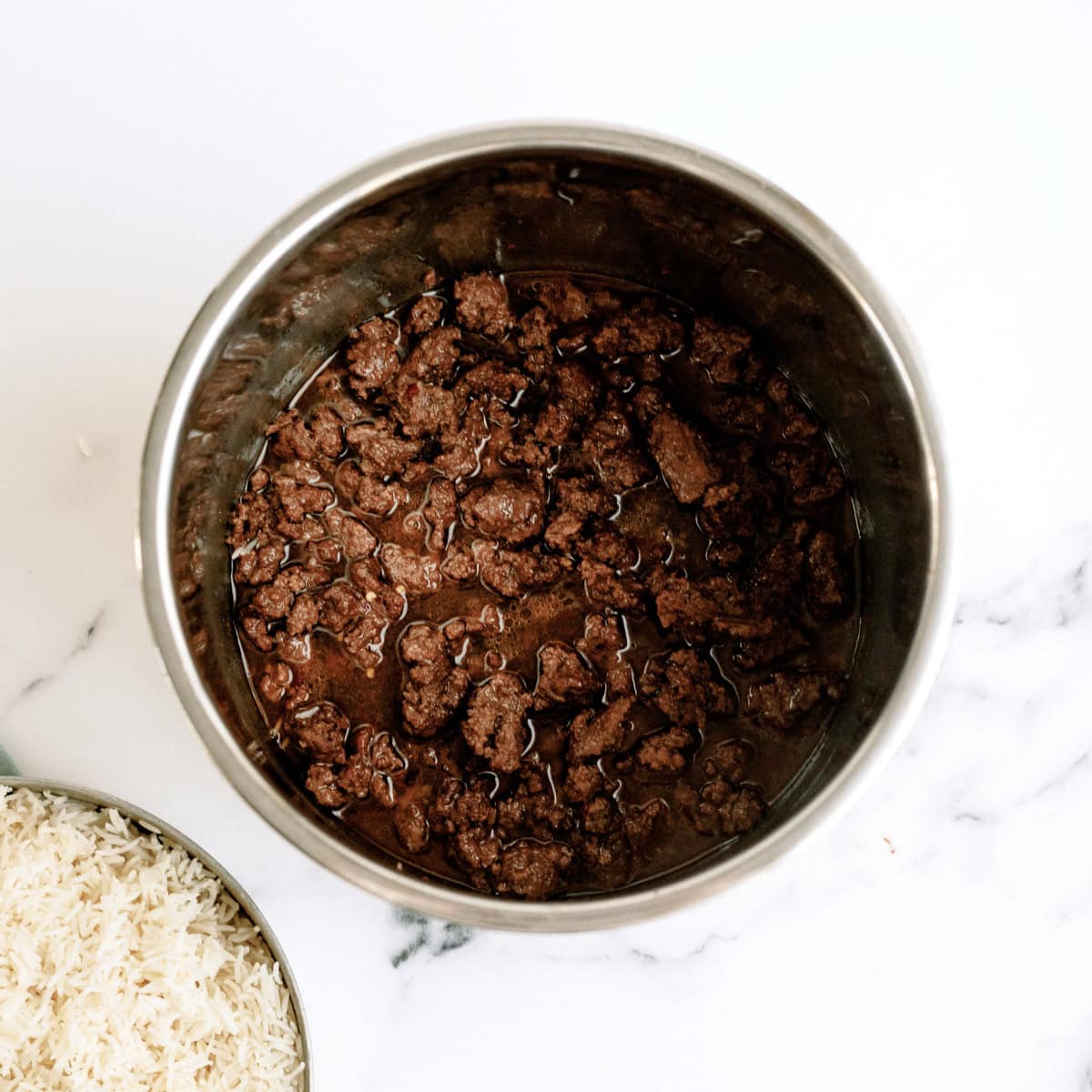 ground beef cooked in beef broth with rice on the side