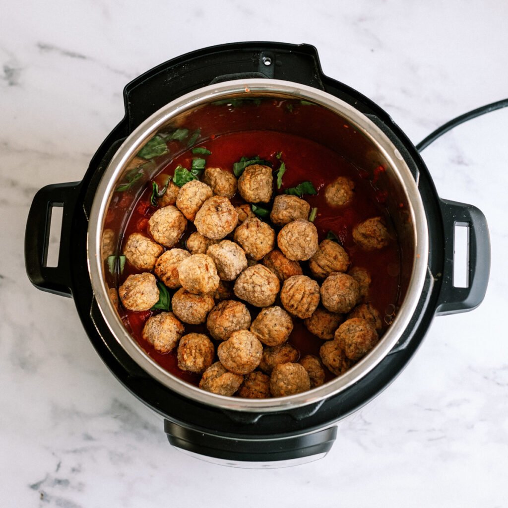 meatballs, tomato puree, diced tomatoes, and basil in the instant pot