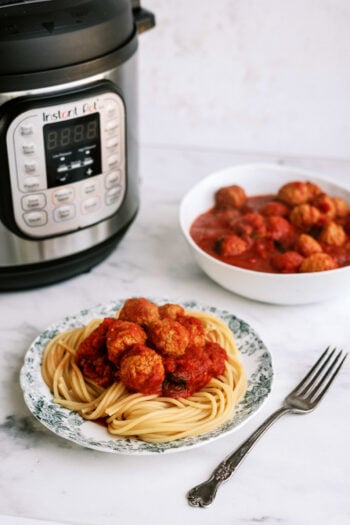 Instant Pot Italian Meatballs plated with spaghetti noodles