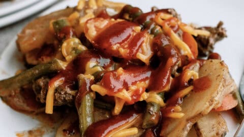 slow cooker hobo dinner with bbq sauce on top