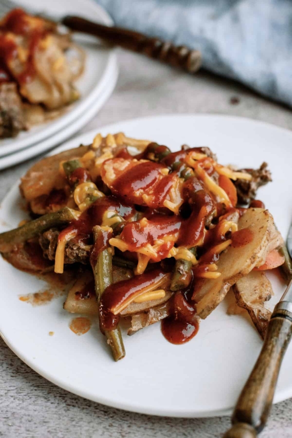 slow cooker hobo dinner with bbq sauce on top