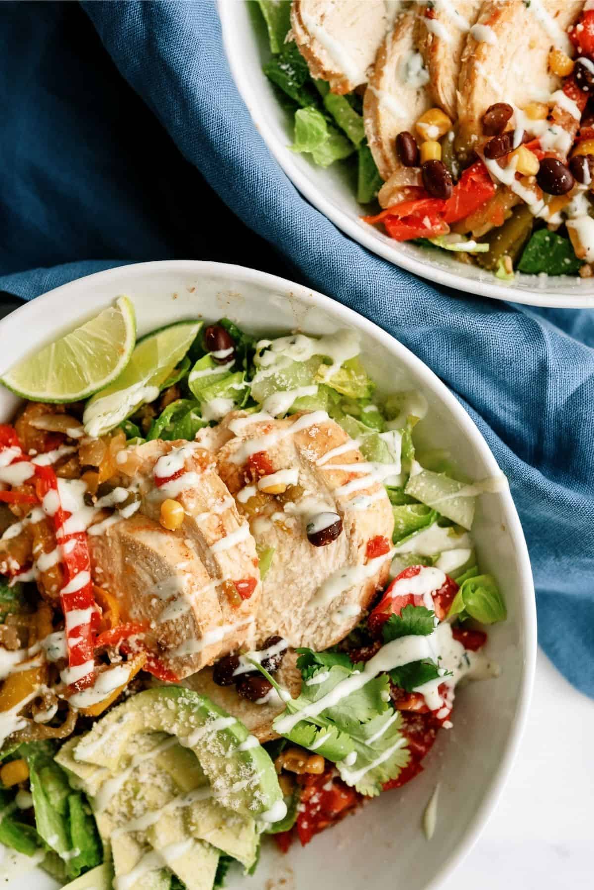 Instant Pot Chicken Fajitas in bowls  on top of lettuce