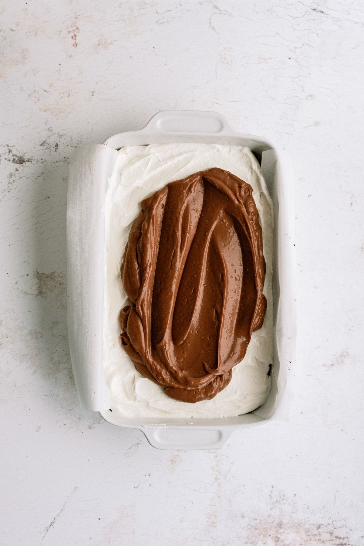 pudding layer spread over cream cheese layer on brownies