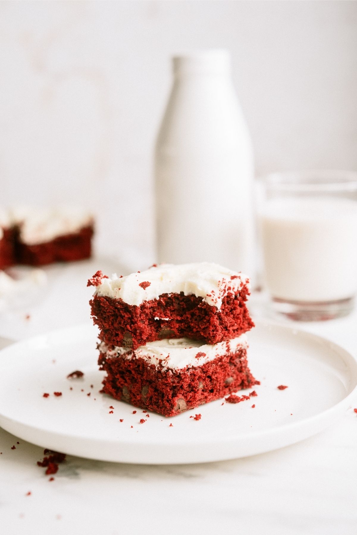 Red Velvet Brownies with White Chocolate buttercream frosting on a plate
