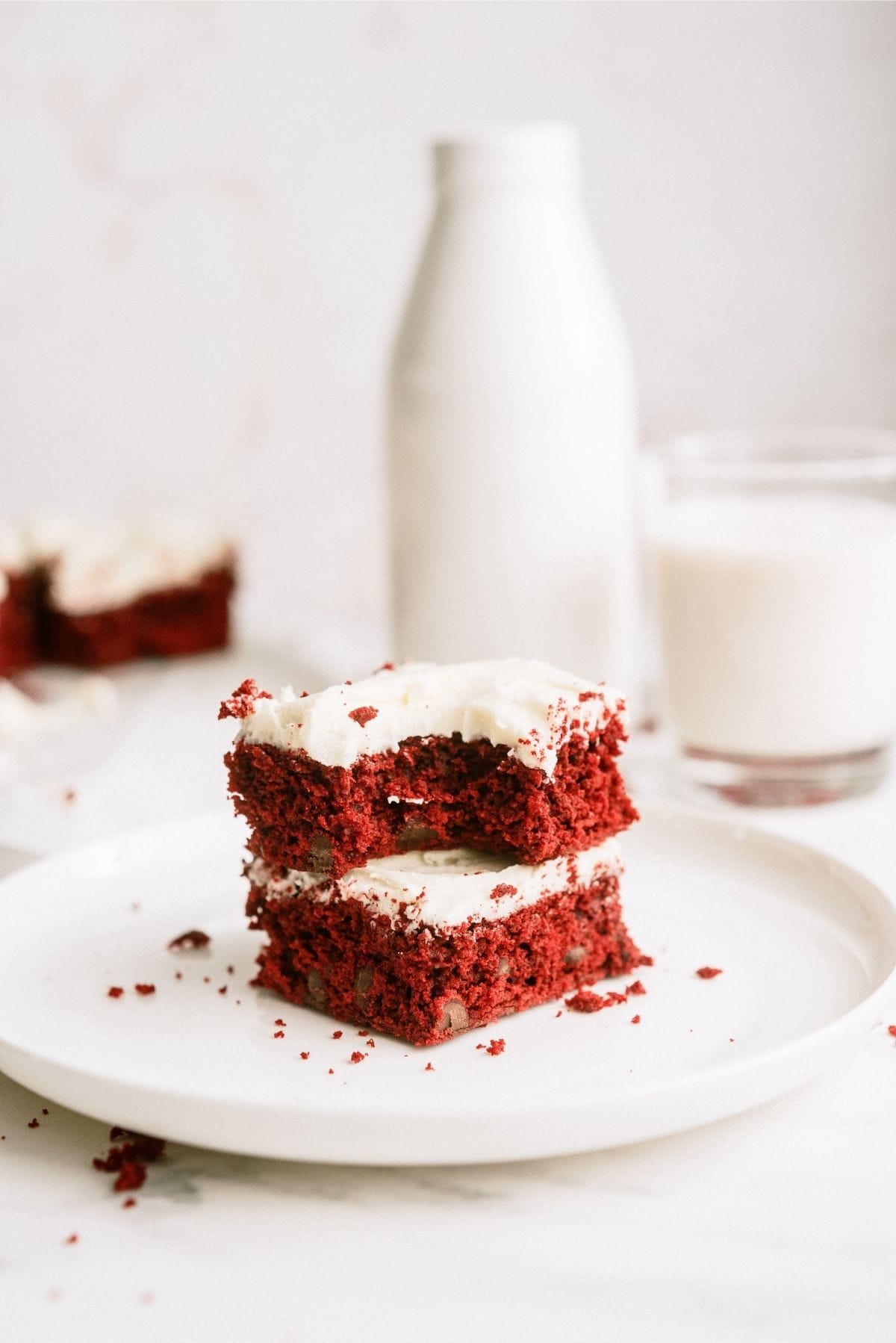 Red Velvet Brownies with White Chocolate buttercream frosting on a plate