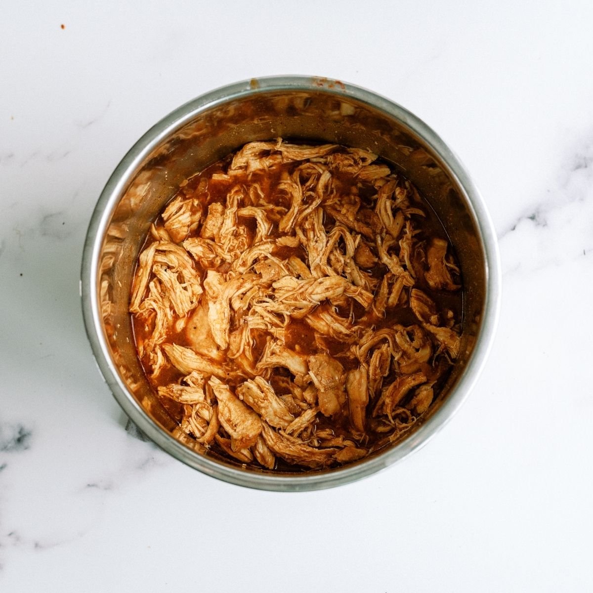 Shredded BBQ Chicken mixed with juices in Instant Pot