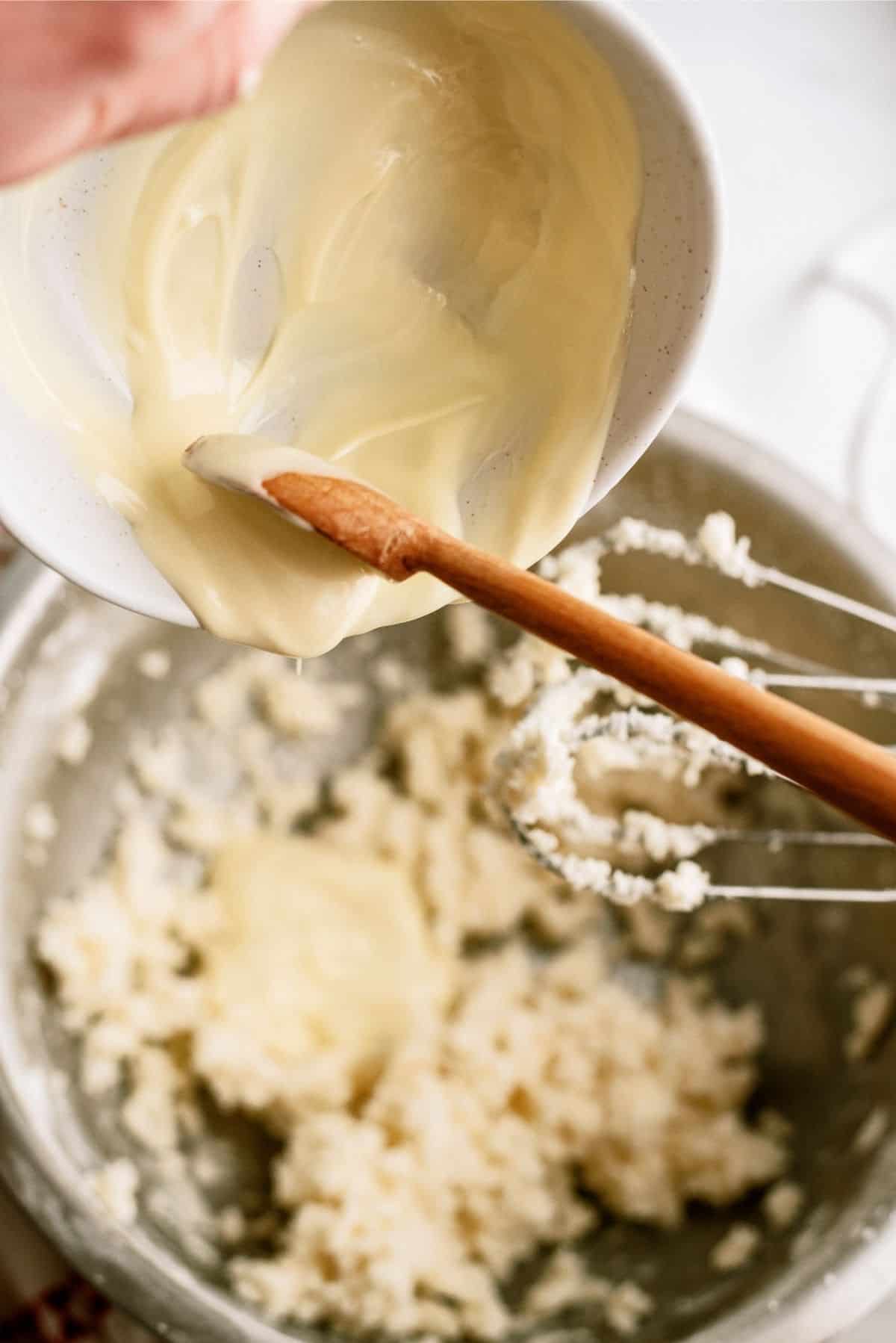 White Chocolate poured into buttercream frosting mixture