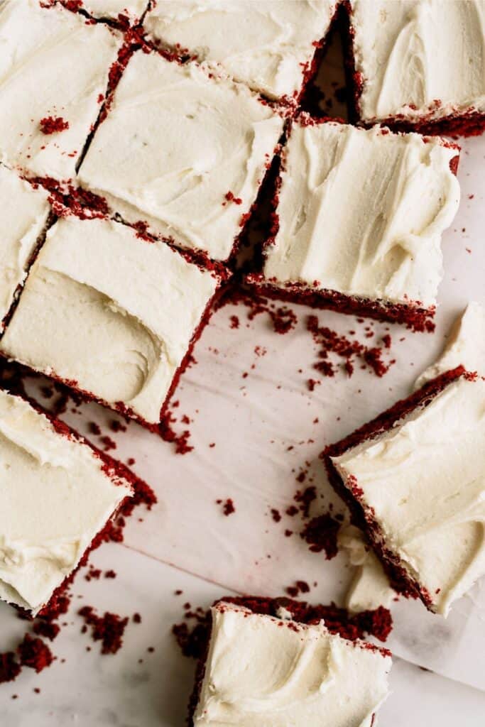 Red Velvet Brownies with White Chocolate Buttercream Frosting cut into squares.