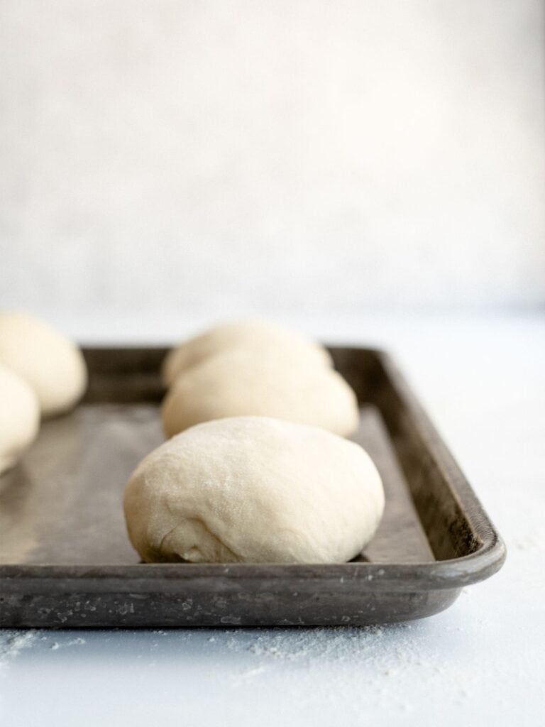 Homemade Bread Bowls dough balls on a baking sheet.