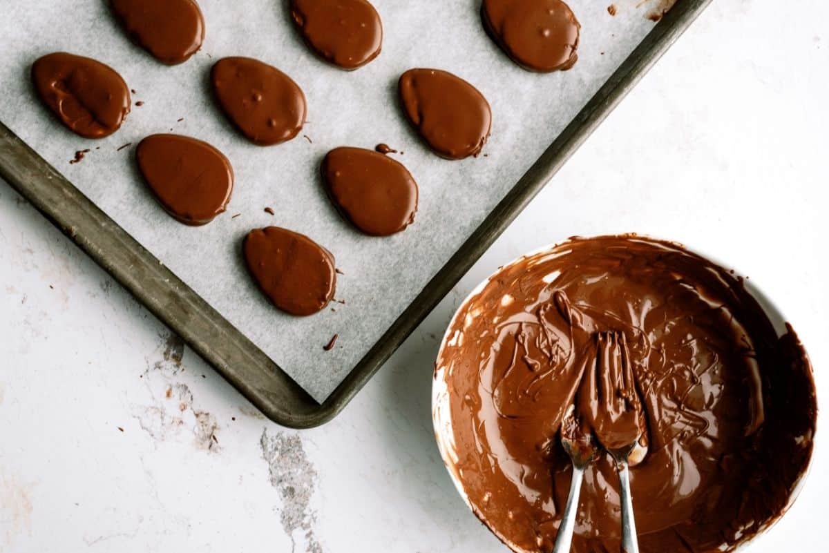 Homemade Reese's Eggs dipped in chocolate on cookie sheet