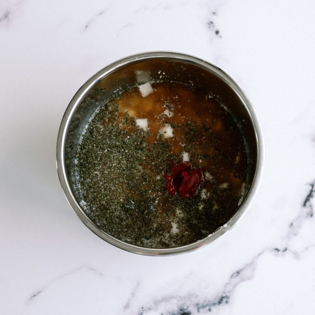 Broth and seasonings in Instant Pot.