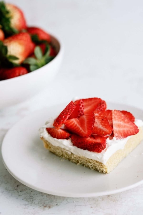 Strawberry Shortcake Bar on a plate topped with fresh strawberries.