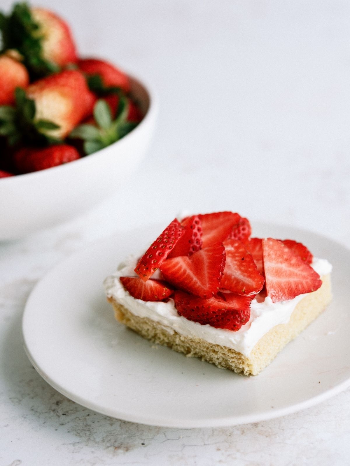 Strawberry Shortcake Bar on a plate with fresh strawberries on top