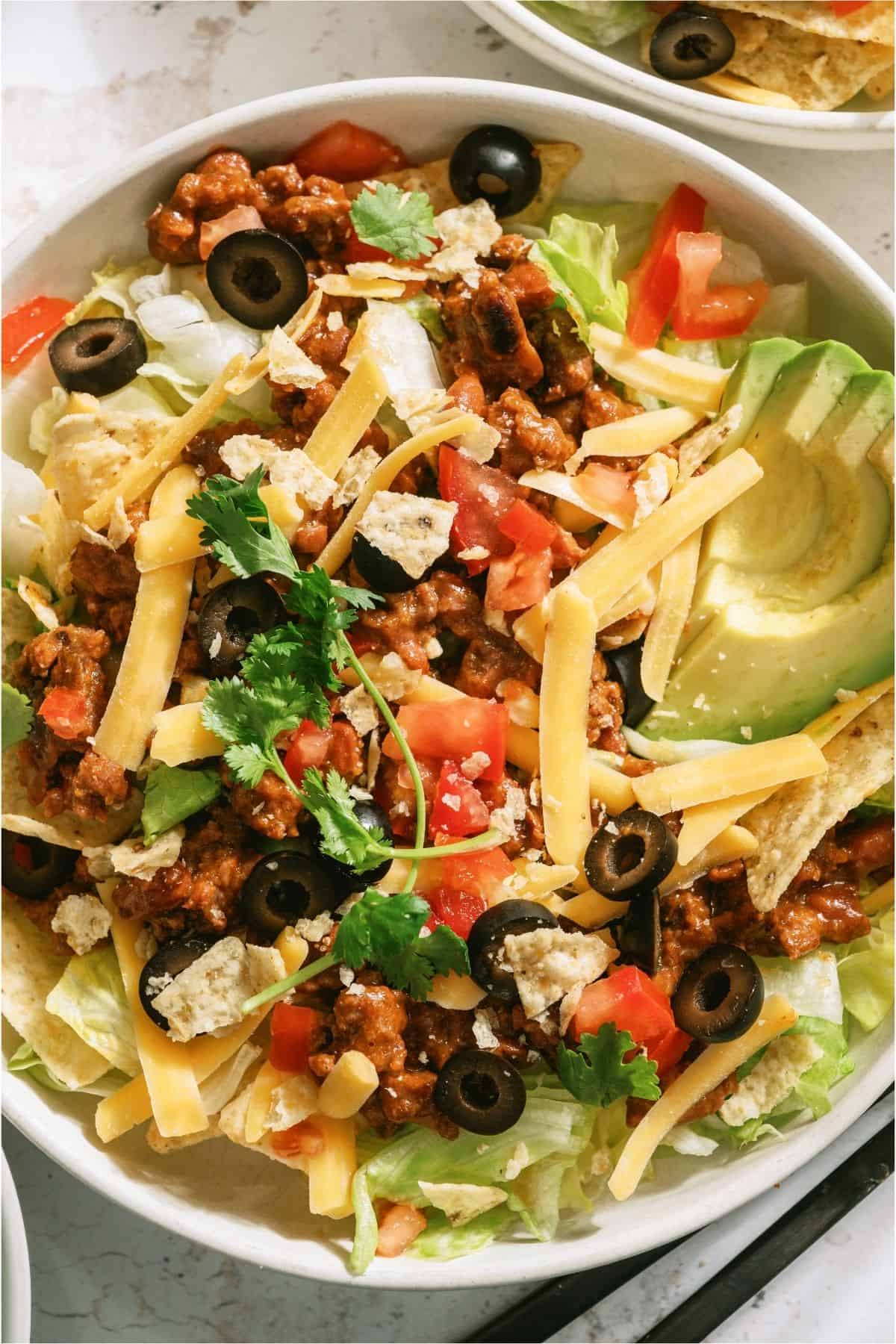 Close up of Taco Salad in a bowl with toppings.