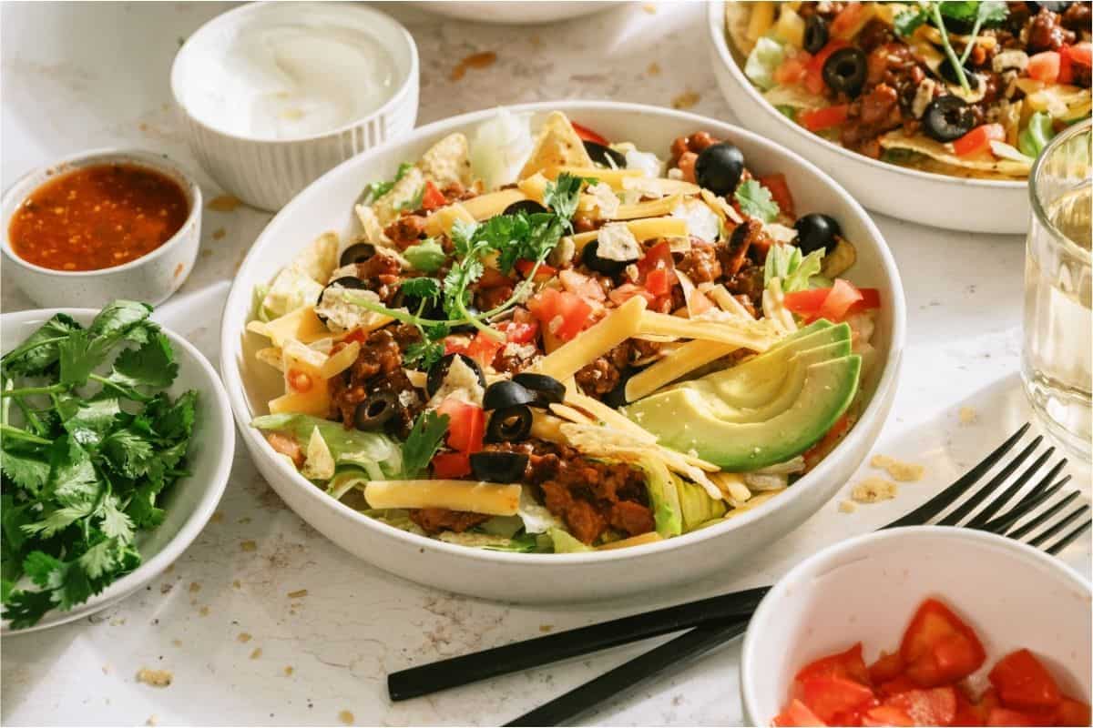 Taco Salad in a bowl with toppings.