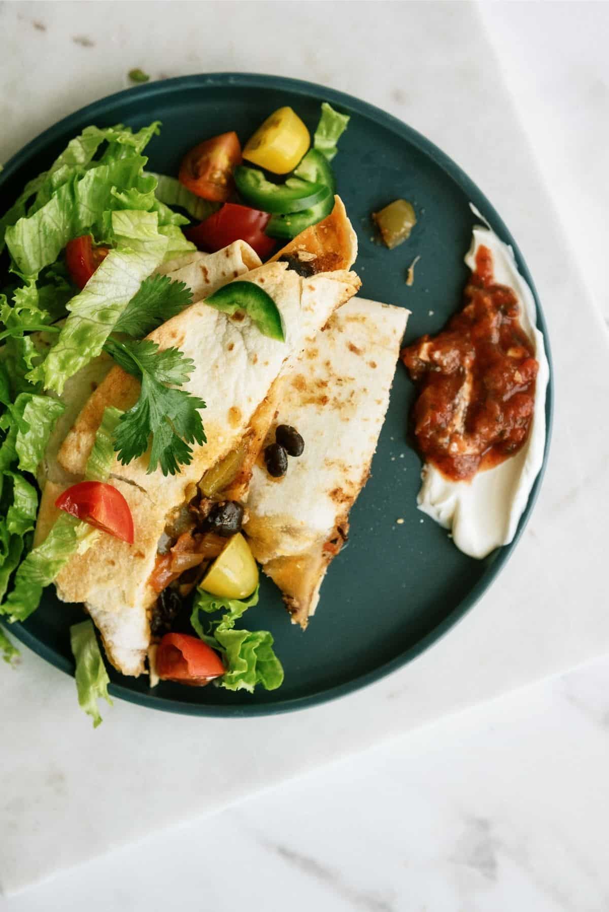 Baked Sheet Pan Ground Beef Quesadillas with toppings on blue plate