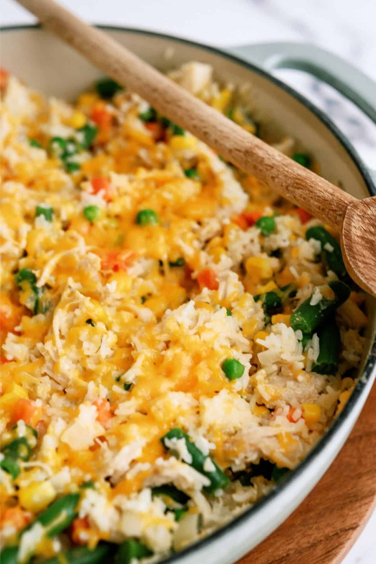 Place lid on pot to melt cheese for Creamy Chicken and Rice Casserole Skillet