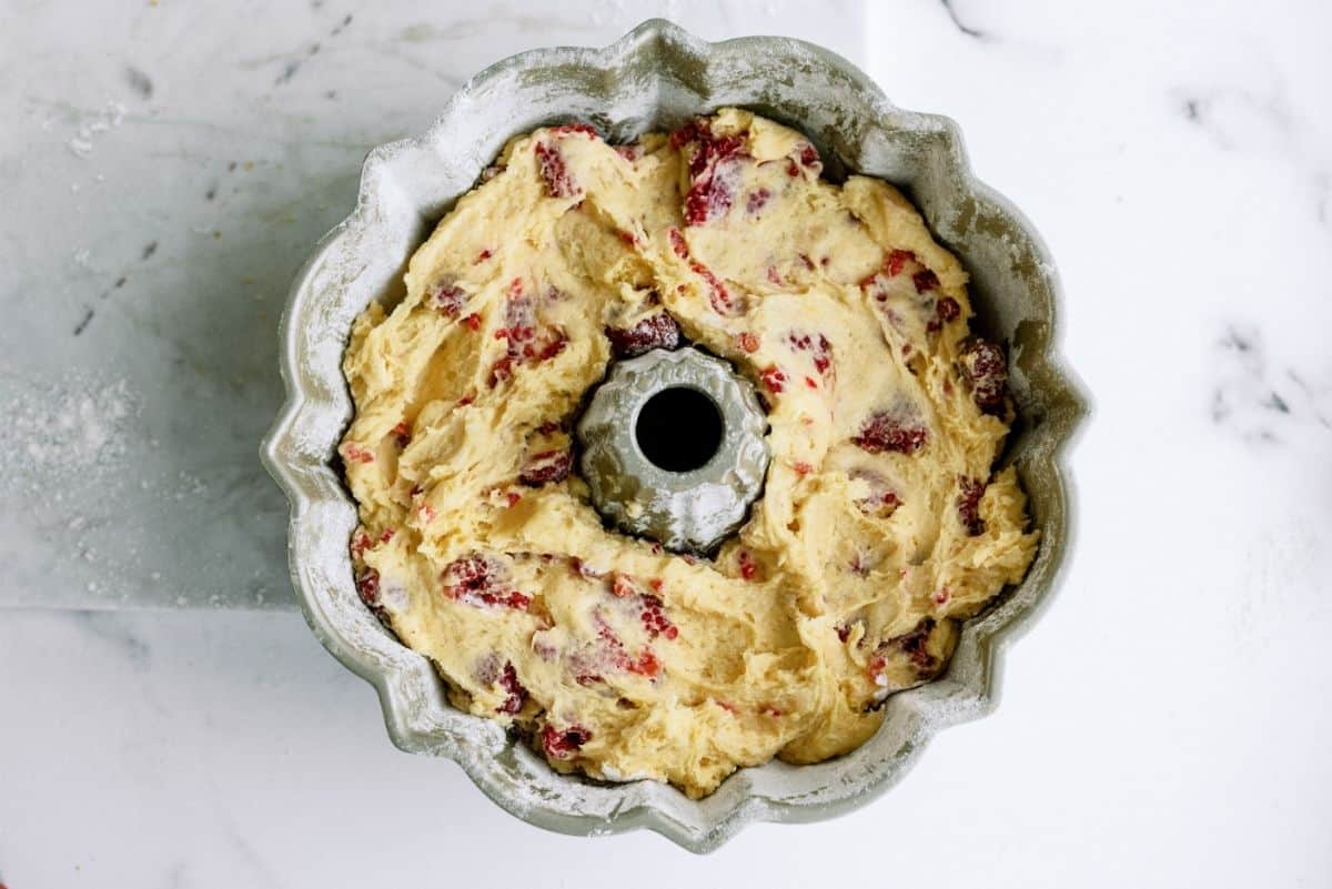 Fresh Raspberries mixed into cake batter in bundt cake pan