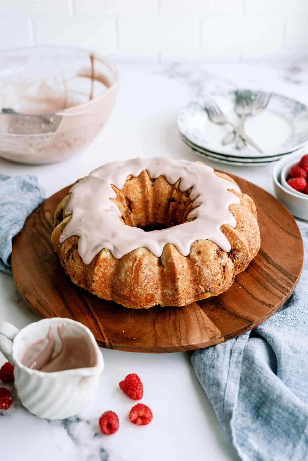 Fresh Raspberry Yogurt Bundt Cake with Raspberry Frosting on cutting board