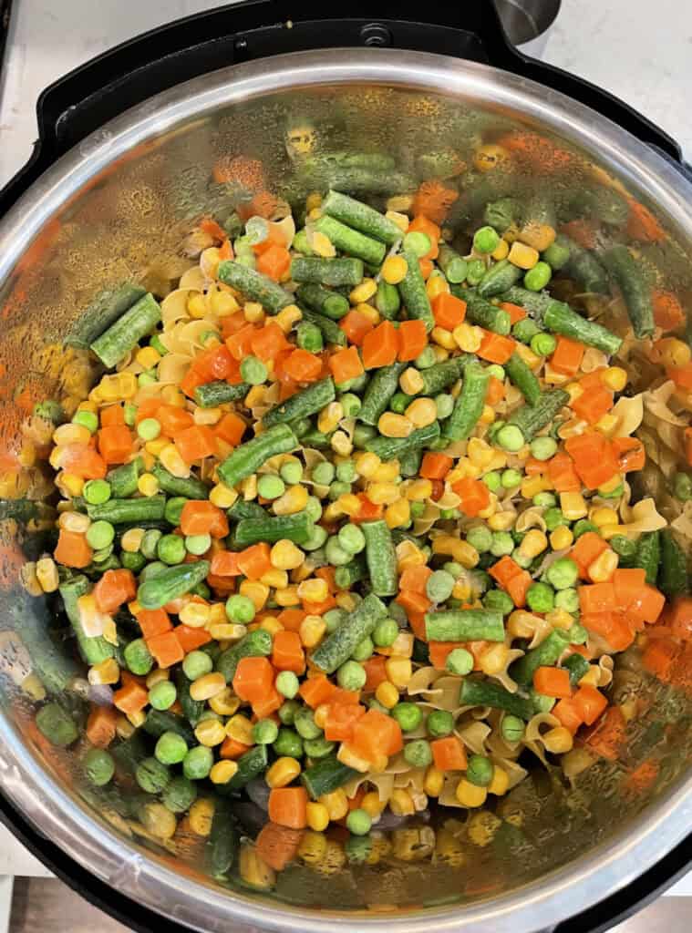Frozen vegetables and noodles in the instant pot.