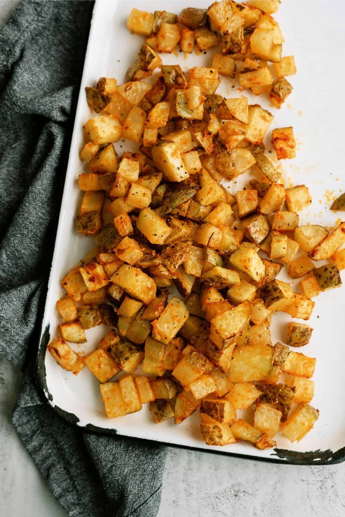 Instant Pot Air Fryer Roasted Potatoes on white serving plater.