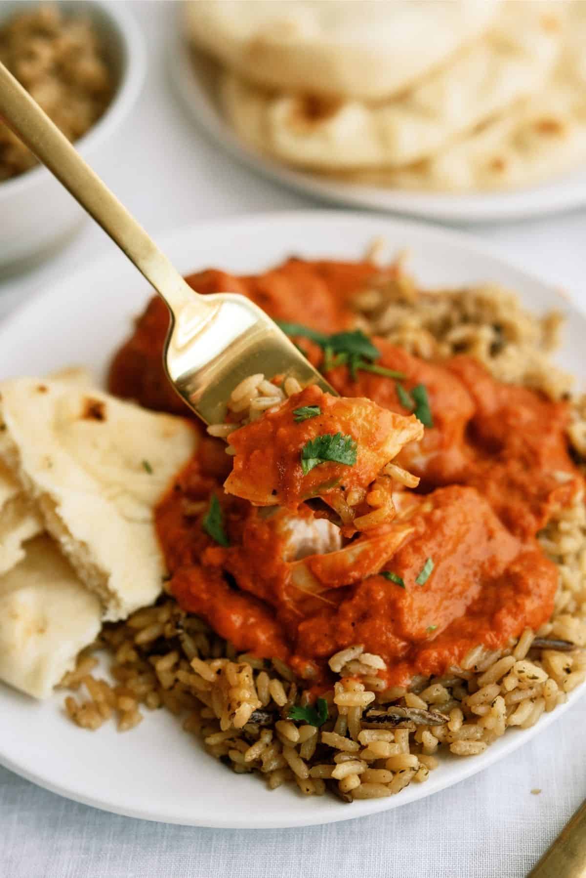 Instant Pot Butter Chicken served over rice on white plate