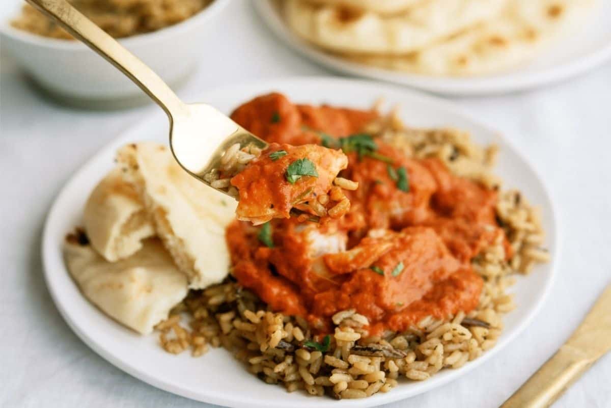 Instant Pot Butter Chicken over rice on a white plate