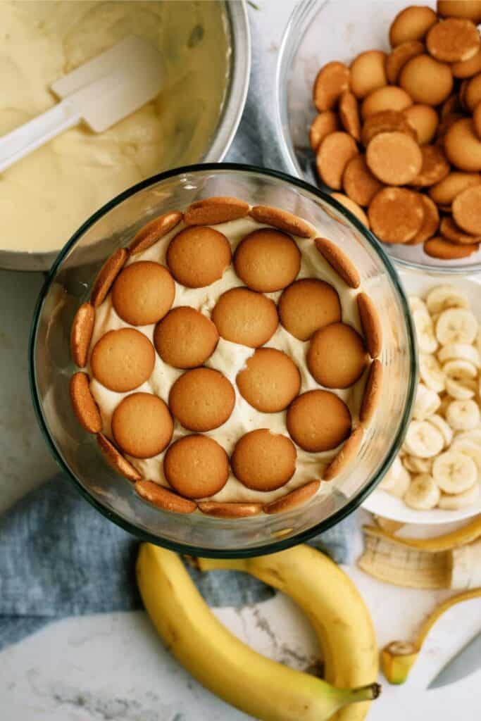 Nilla wafers on top of pudding mixture in trifle dish.