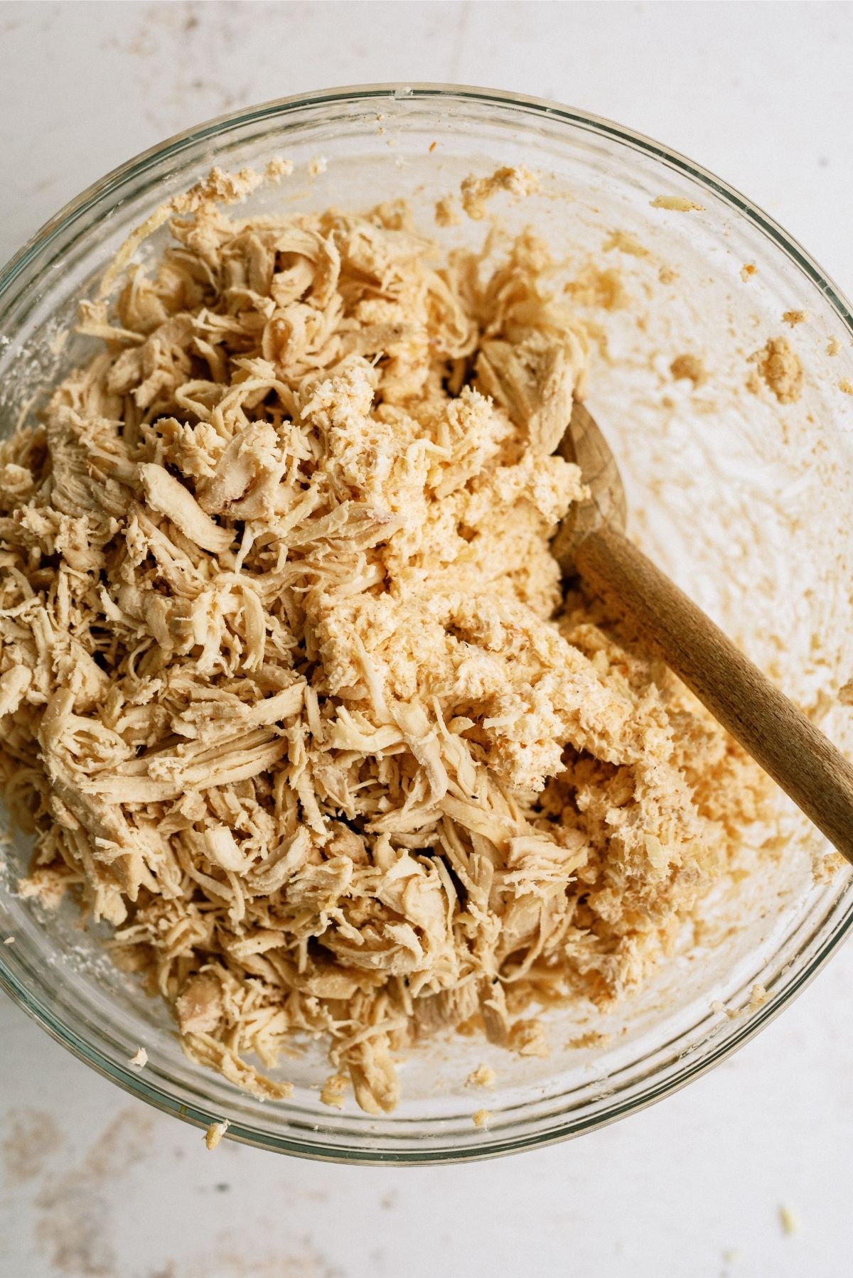 Shredded Chicken mixture in a glass bowl for Chimichangas