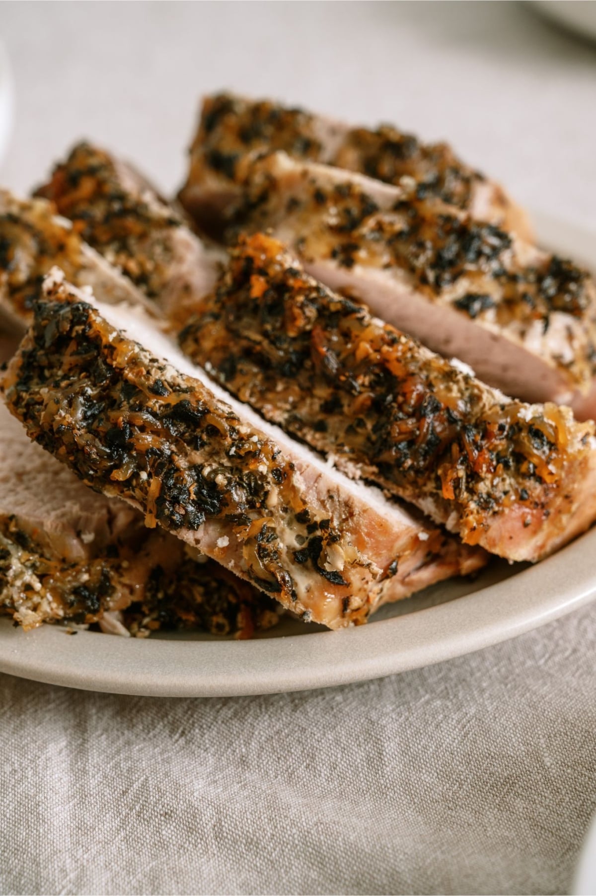 Slow Cooker Parmesan Honey Pork Roast sliced on a plate.