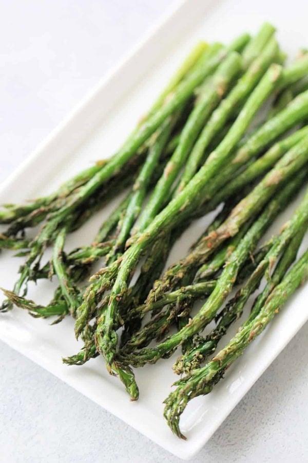 Air Fryer Asparagus on a white serving platter.