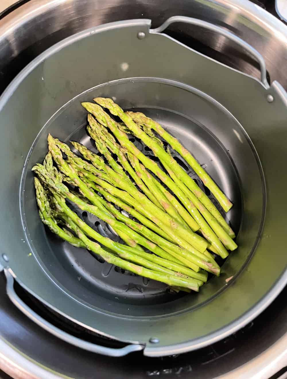 asparagus in the bottom of an air fryer