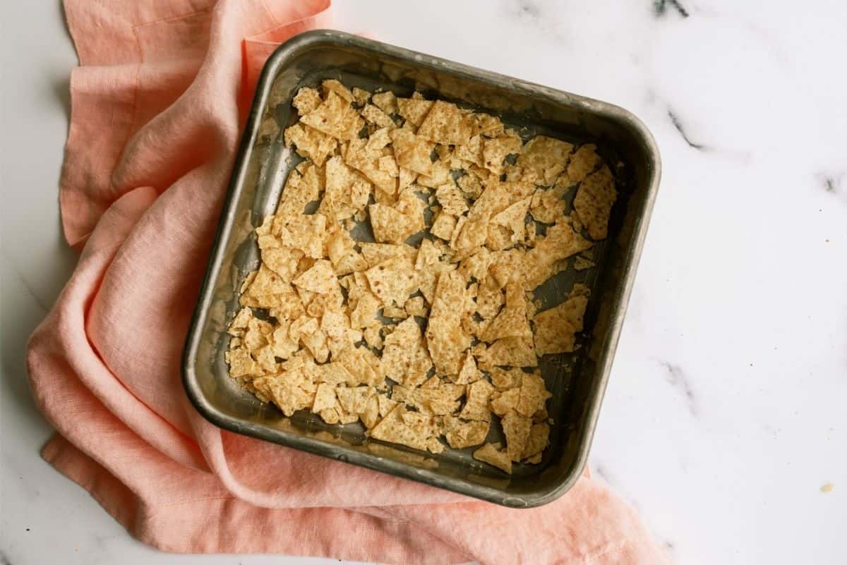 Crushed tortilla chips in 8x8 pan