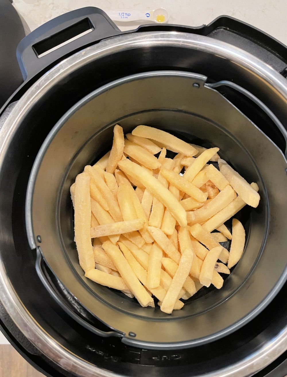 frozen french fries in the bottom of the air fryer