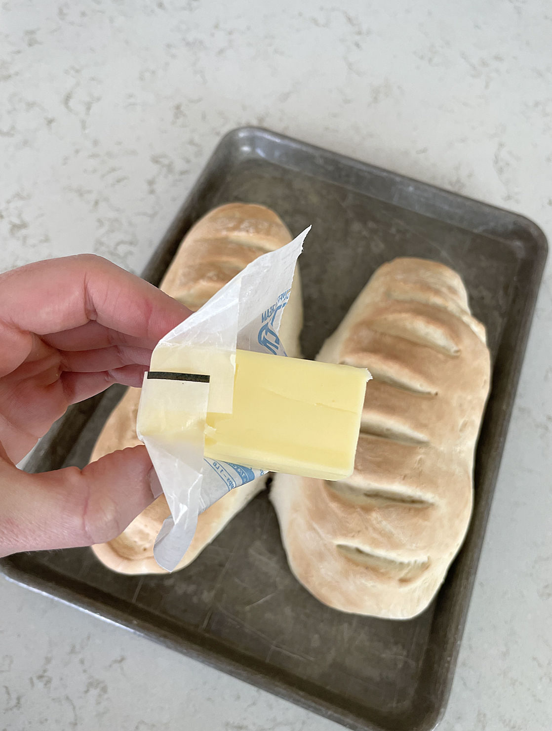 rub butter on top of loaves as soon as they come out of the oven