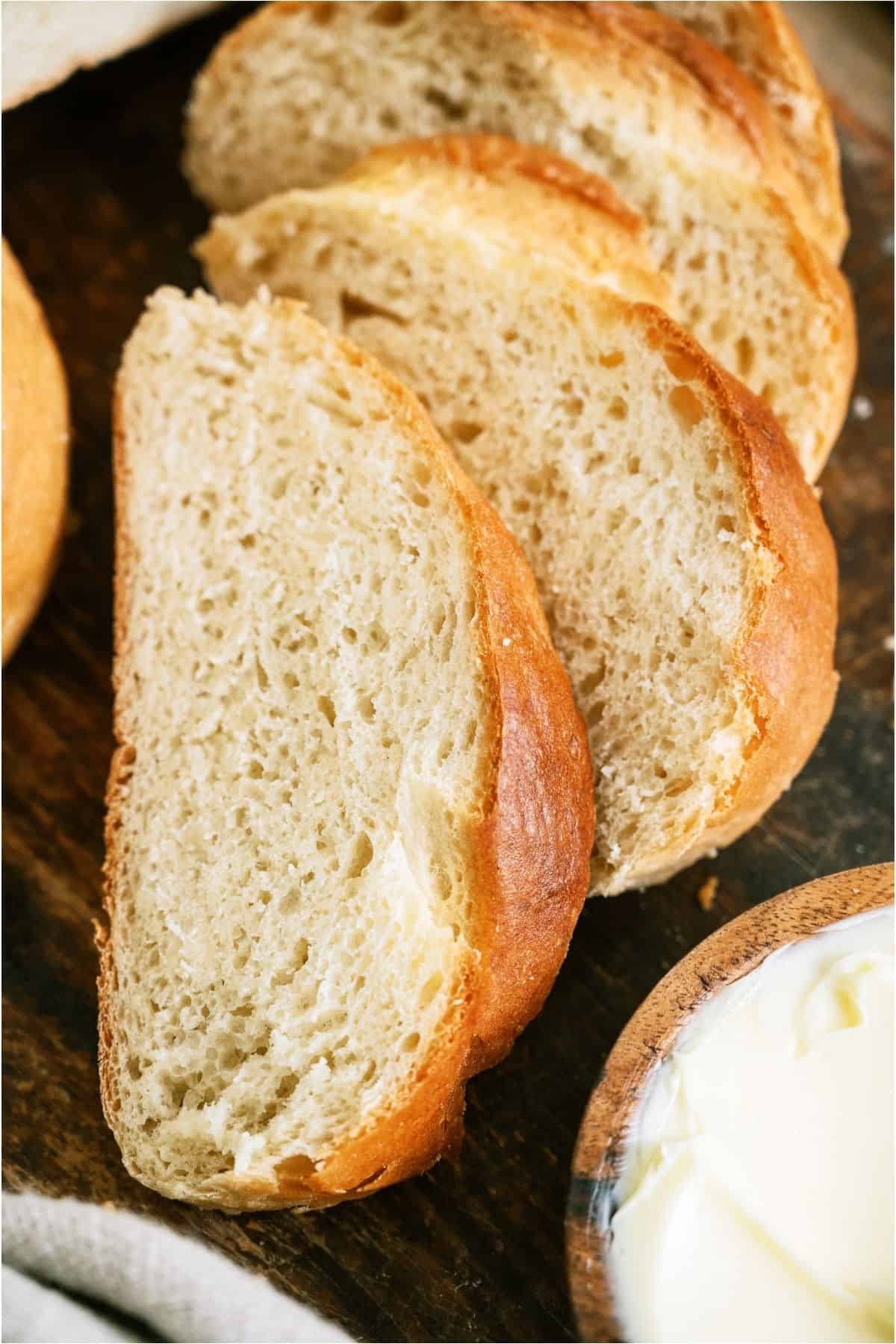 Slices of Homemade French Bread on a cutting board.