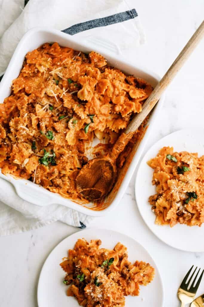 Instant Pot Ground Beef Lazy Lasagna in a white serving dish with a wooden spoon.